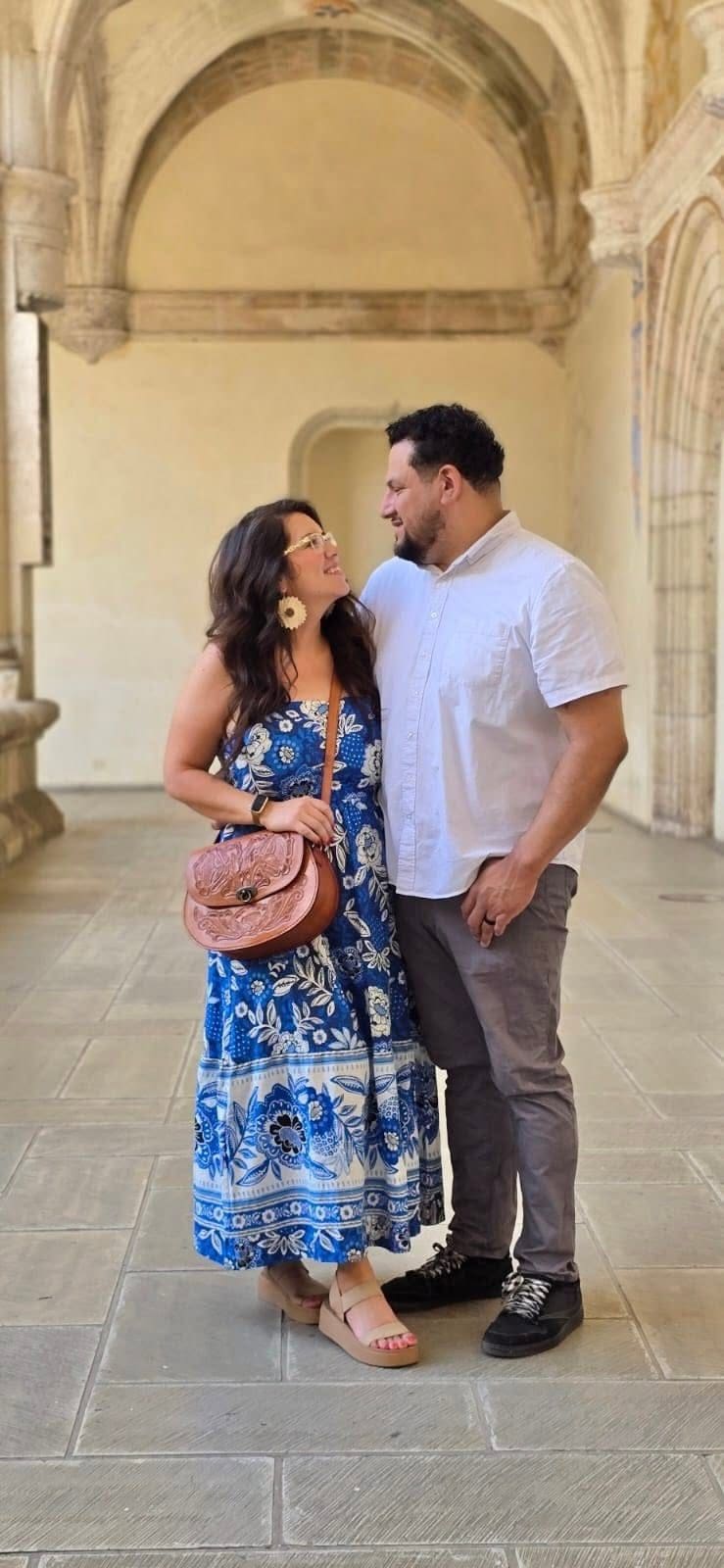 Newlywed couple embracing and smiling in a historic Oaxaca cloister during their honeymoon